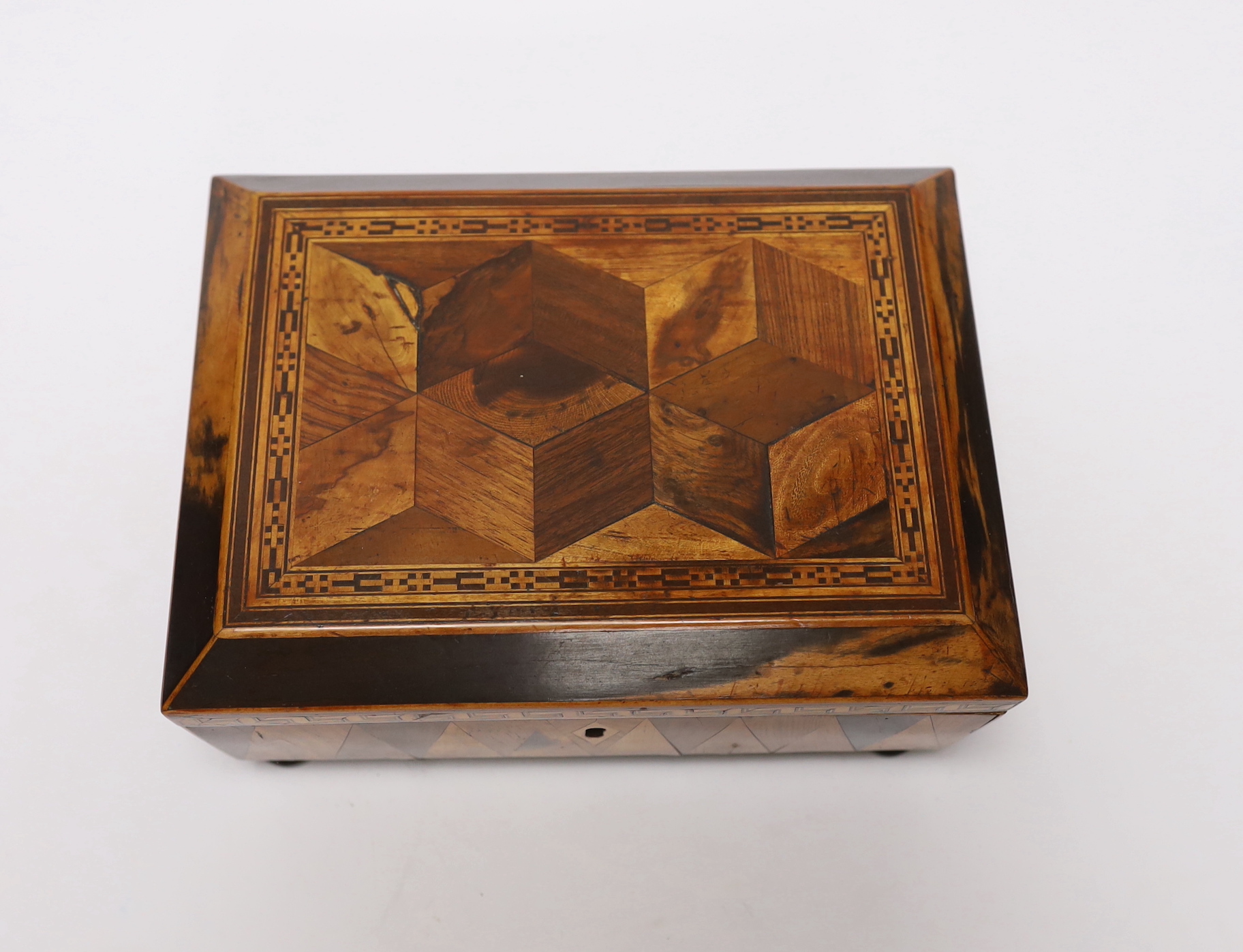 An early 19th century specimen wood, perspective cube marquetry box, 20.5cm wide, 9cm high, 15cm deep